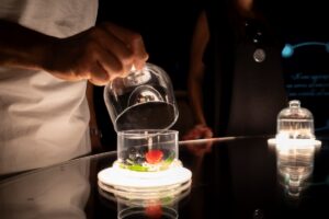 Close-up of guest smelling wine, capturing the aromas of ripe fruits and fresh nature.