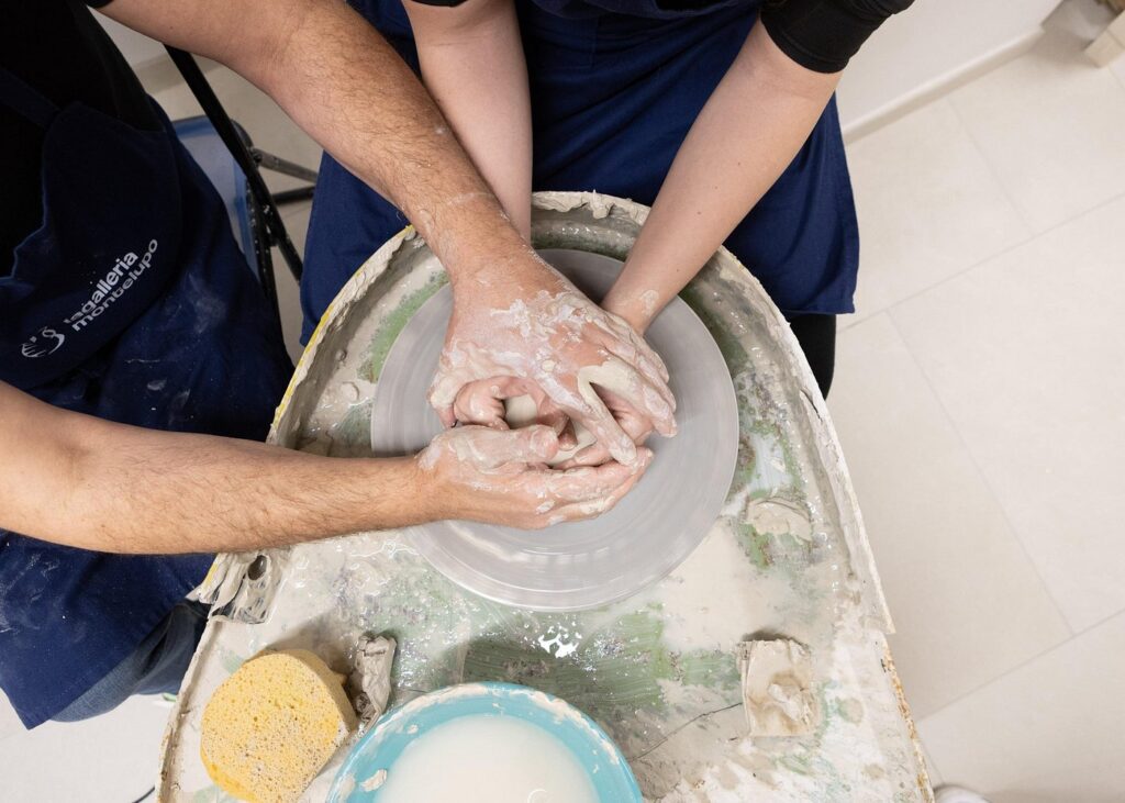 Guest shaping clay during the Tuscan Ceramics Masterclass with Factory Tour near Florence