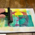 Completing a multicolor monoprint with a brayer at an art for children Florence, Fatacadabra