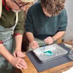 Leo guiding a participant through the Polaroid emulsion lift technique at Fatacadabra, Florence