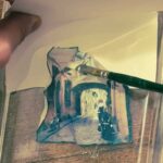 Polaroid emulsion being shaped onto watercolor paper during a hands-on photography Florence session at Fatacadabra