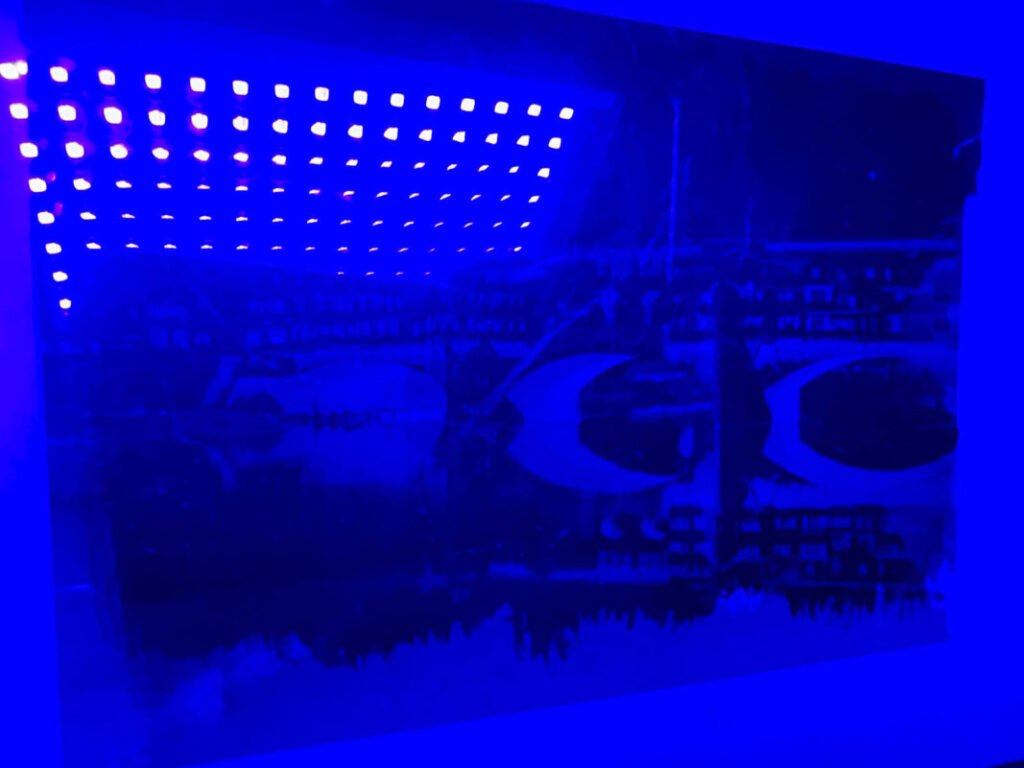 UV lamp exposing a Ponte Vecchio cyanotype print during a photography experience Florence at Fatacadabra