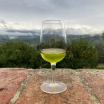 Chianti cooking class with olive oil tasting featuring a glass of fresh extra virgin olive oil overlooking the Chianti hills