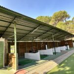 Covered driving range with golf practice bays at a Chianti golf club.