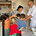 Family group with children during a private tuscan cooking class in florence with market shopping