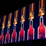 Artistic wine bottle light installation inside the immersive winery experience.