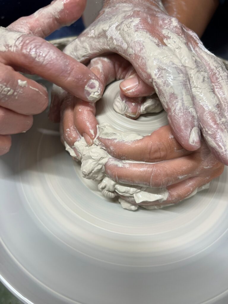 Close-up of guided wheel technique in a Tuscan ceramics masterclass experience