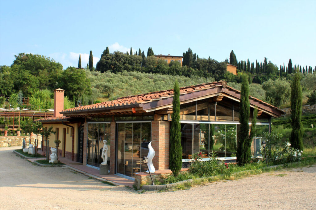 The Bio e Brado organic farm building in Impruneta with Tuscan cypress hills in the background — horseback riding Tuscany