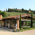 The Bio e Brado organic farm building in Impruneta with Tuscan cypress hills in the background — horseback riding Tuscany