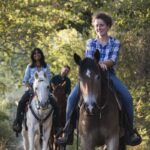 Margherita, local horse riding guide, with horses at an organic farm in Impruneta near Florence, Tuscany.
