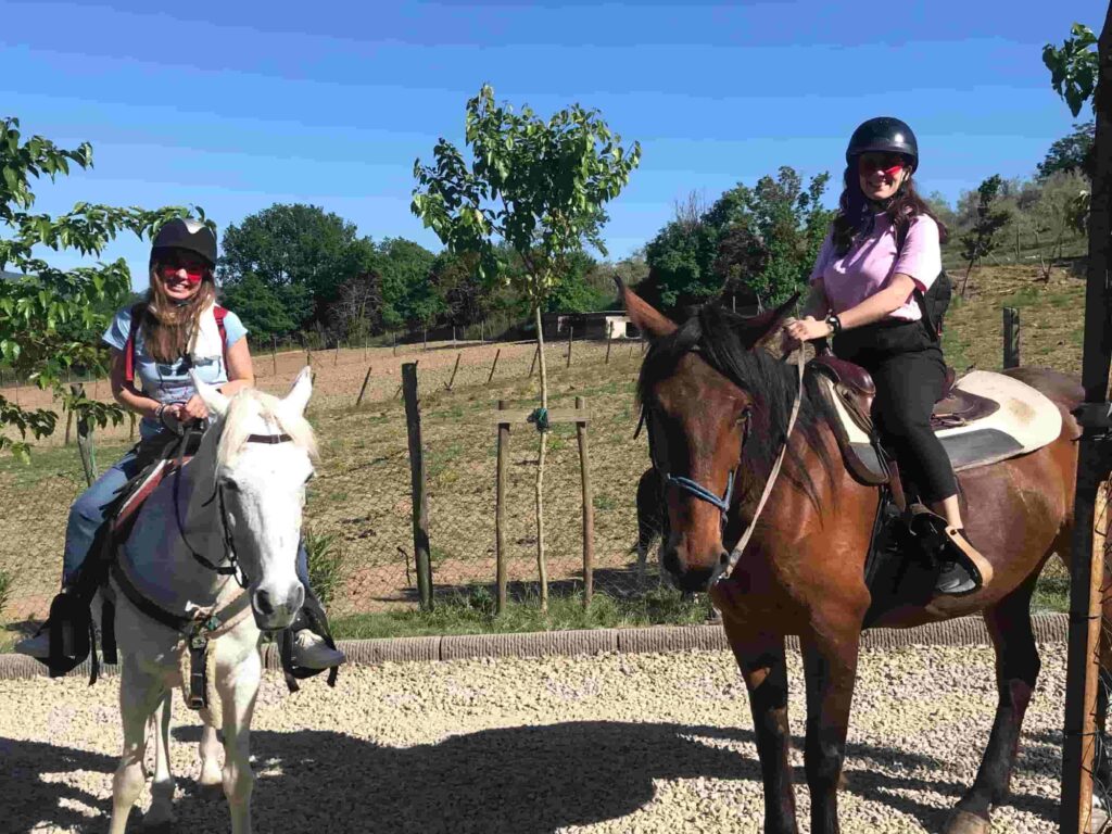 Two women on horseback at Bio e Brado organic farm in Impruneta ready to ride — horseback riding near Florence