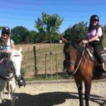 Two women on horseback at Bio e Brado organic farm in Impruneta ready to ride — horseback riding near Florence